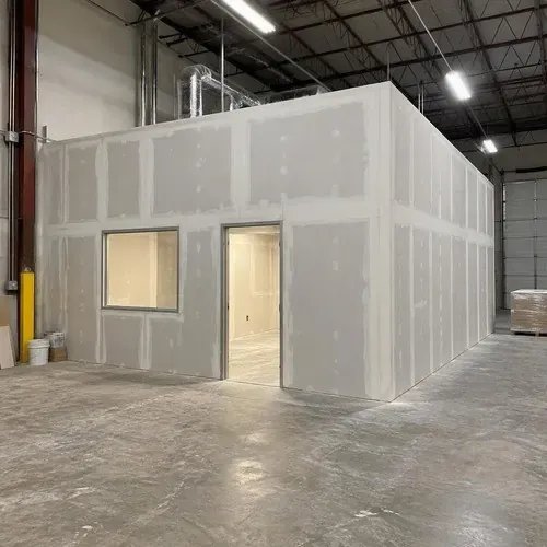 Warehouse office box finished in unpainted drywall on a commercial drywall project in Kingston, ON
