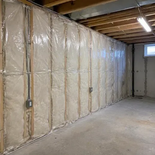 Insulated basement wall ready for drywall during insulation and drywall work in Kingston, ON