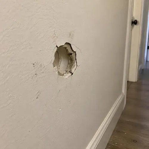 Doorknob dent punched through hallway drywall on a drywall repair job in Kingston, ON