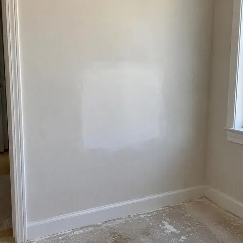Sanded drywall patch ready for paint on a drywall repair job in Kingston, ON