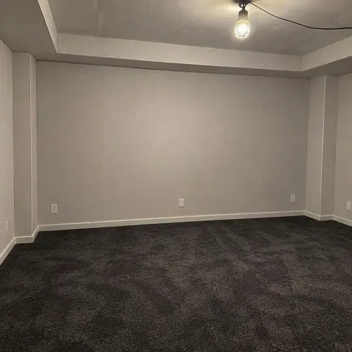 Finished soundproofed home theatre wall unpainted on a drywall soundproofing job in Kingston, ON