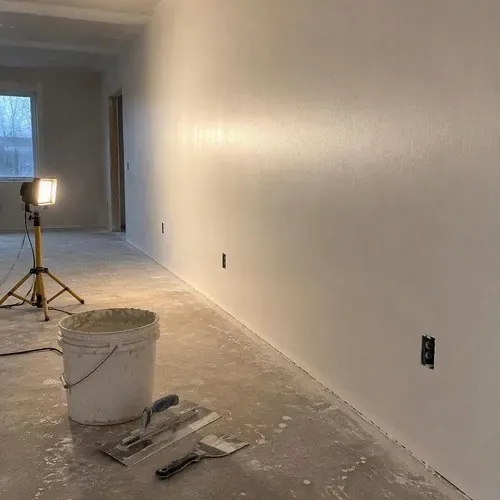 Skim coated wall at level five finish during drywall taping and finishing in Kingston, ON