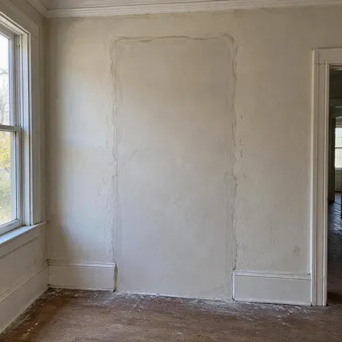 Plaster patched around an old doorway opening during lath and plaster repair in a Kingston home