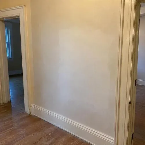 Restored smooth plaster wall in older home during lath and plaster repair in a Kingston home