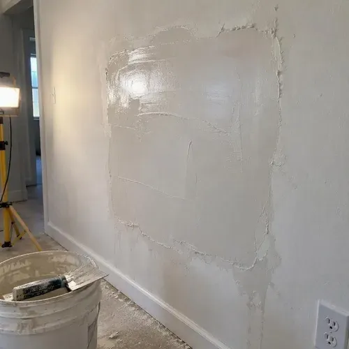 Skim coat applied over a repaired plaster section in a Brockville heritage home