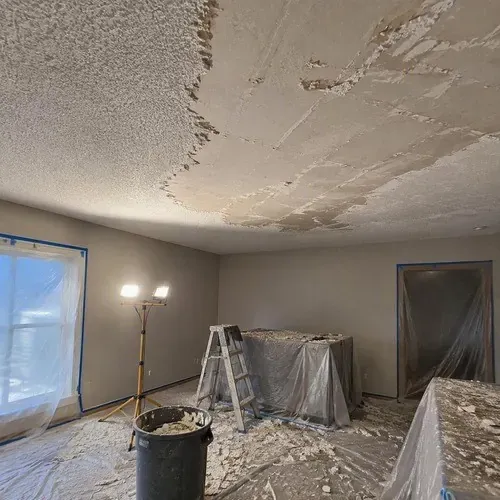 Partly scraped ceiling showing gouges to repair during popcorn ceiling removal in Kingston, ON
