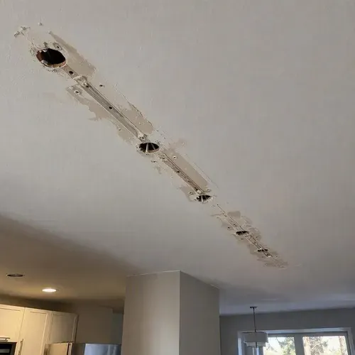 Holes left in ceiling after track lighting removed during pot light hole repair in Kingston, ON