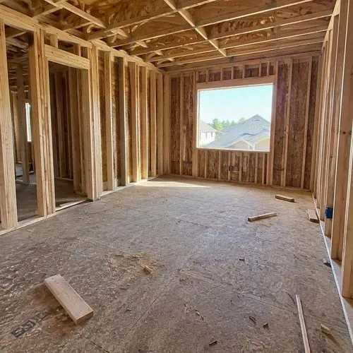 Bare stud framing in empty new bedroom on a residential drywall installation in Kingston, ON