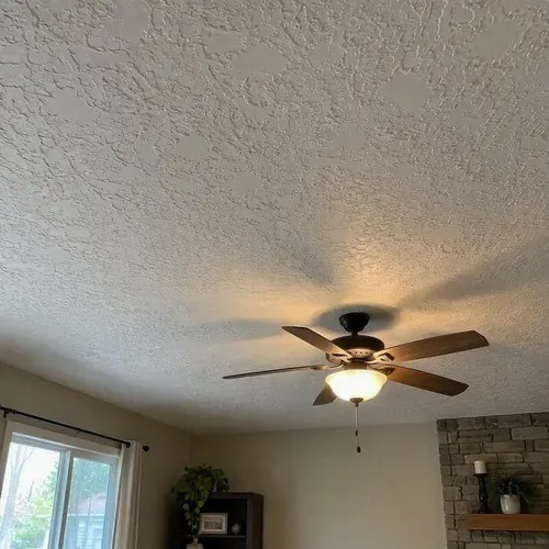 Knockdown textured ceiling in suburban living room during textured ceiling and wall repair in Kingston, ON