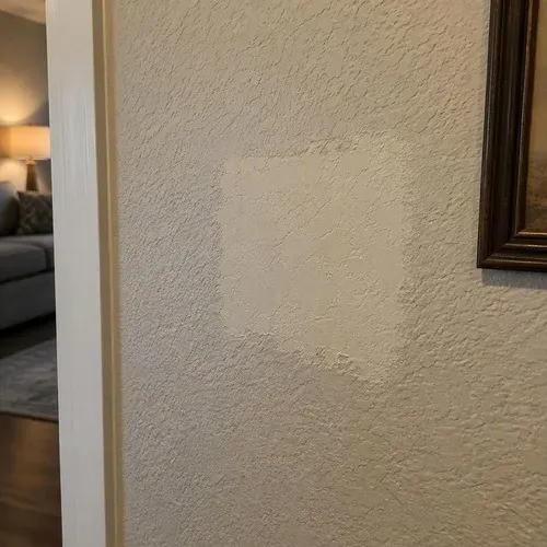 Mismatched texture patch on repaired wall during textured ceiling and wall repair in Kingston, ON