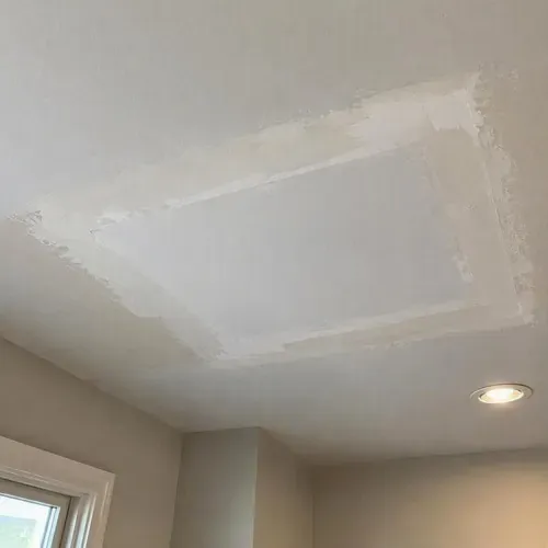New drywall patch replacing water damaged ceiling during water damage drywall repair in Kingston, ON
